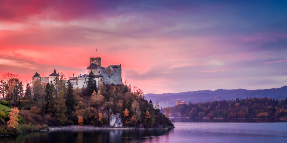 Beautiful castle by the lake at pink dusk, Poland